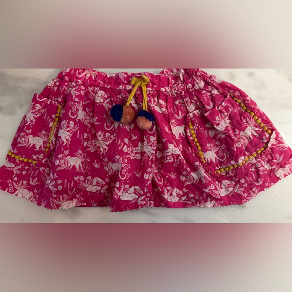 Mini Boden hot pink cotton skirt with an animal print and pom-pom details.